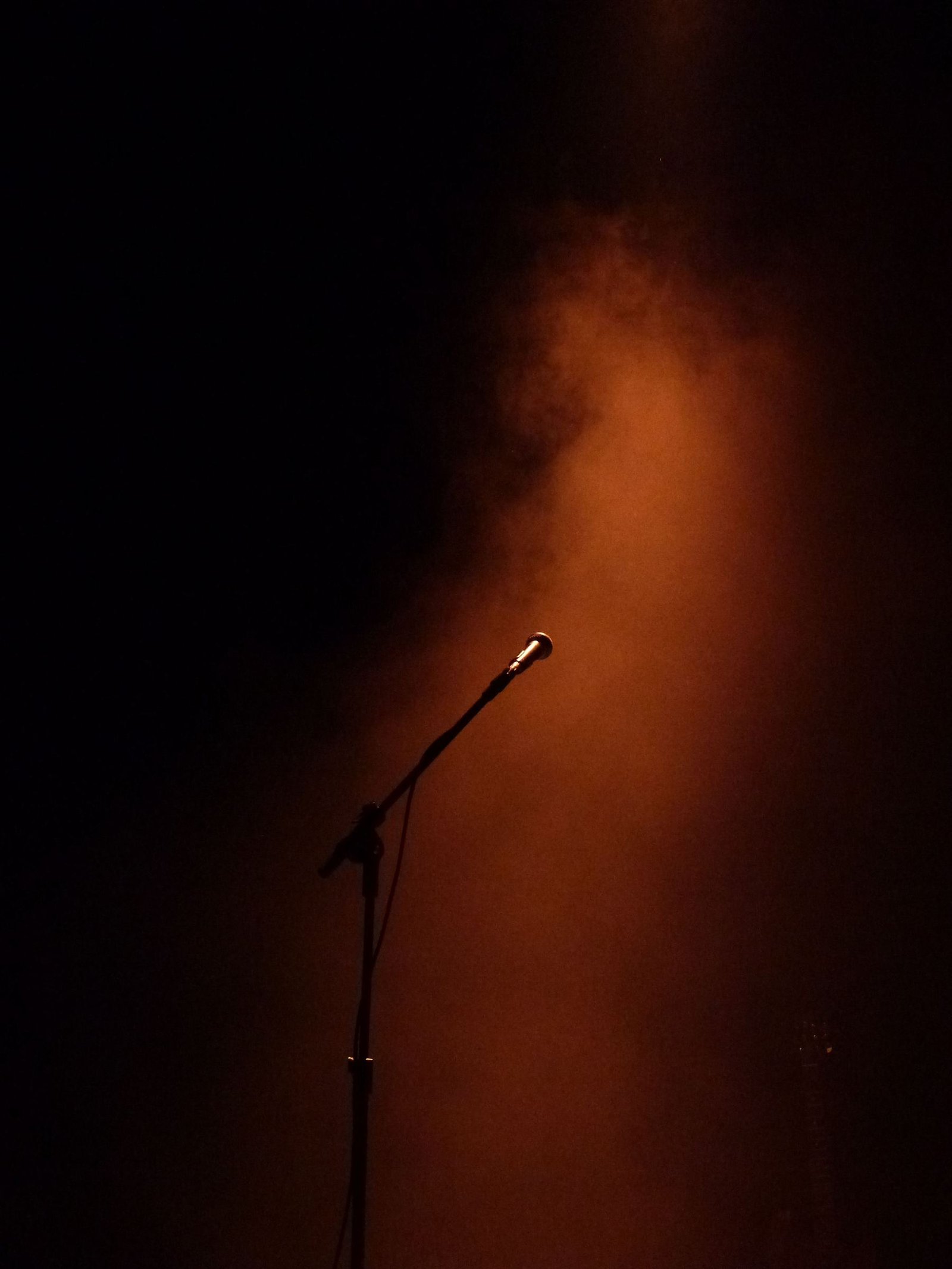 A microphone on a dim stage