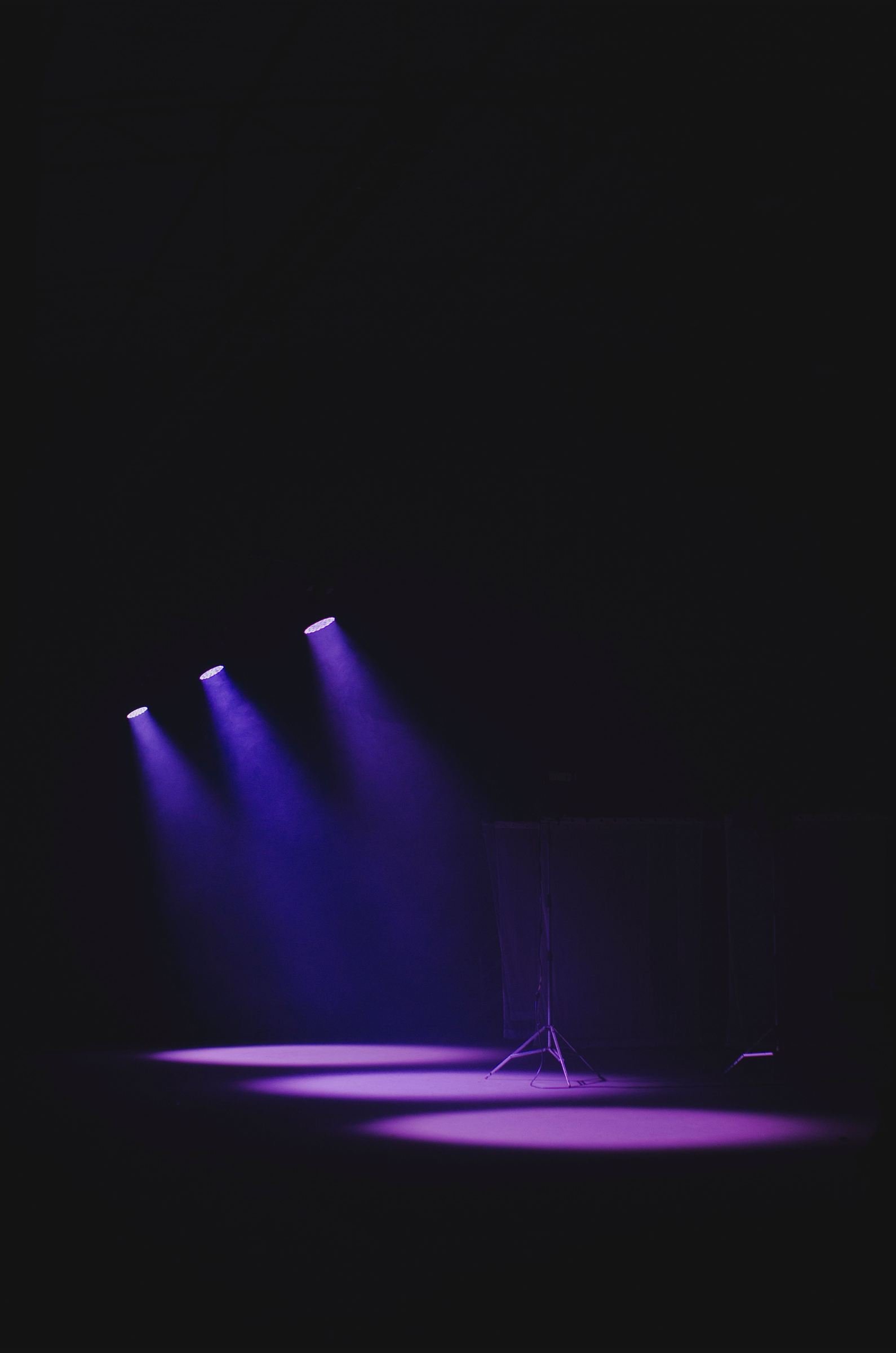Empty stage under purple spotlights